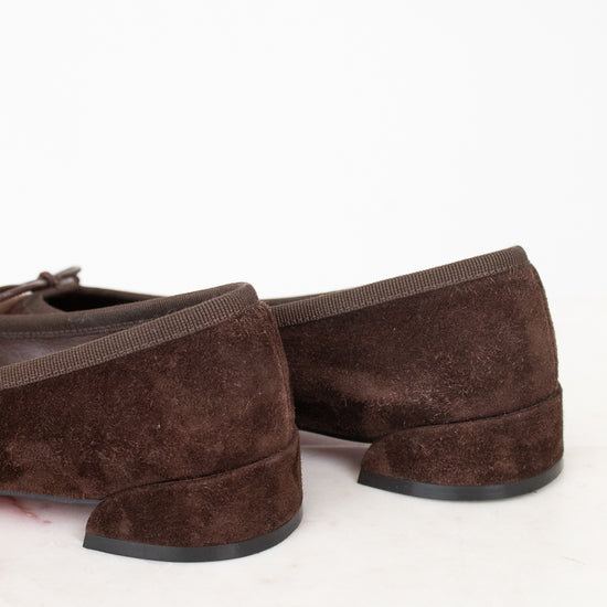 Heel view of brown suede ballet flats