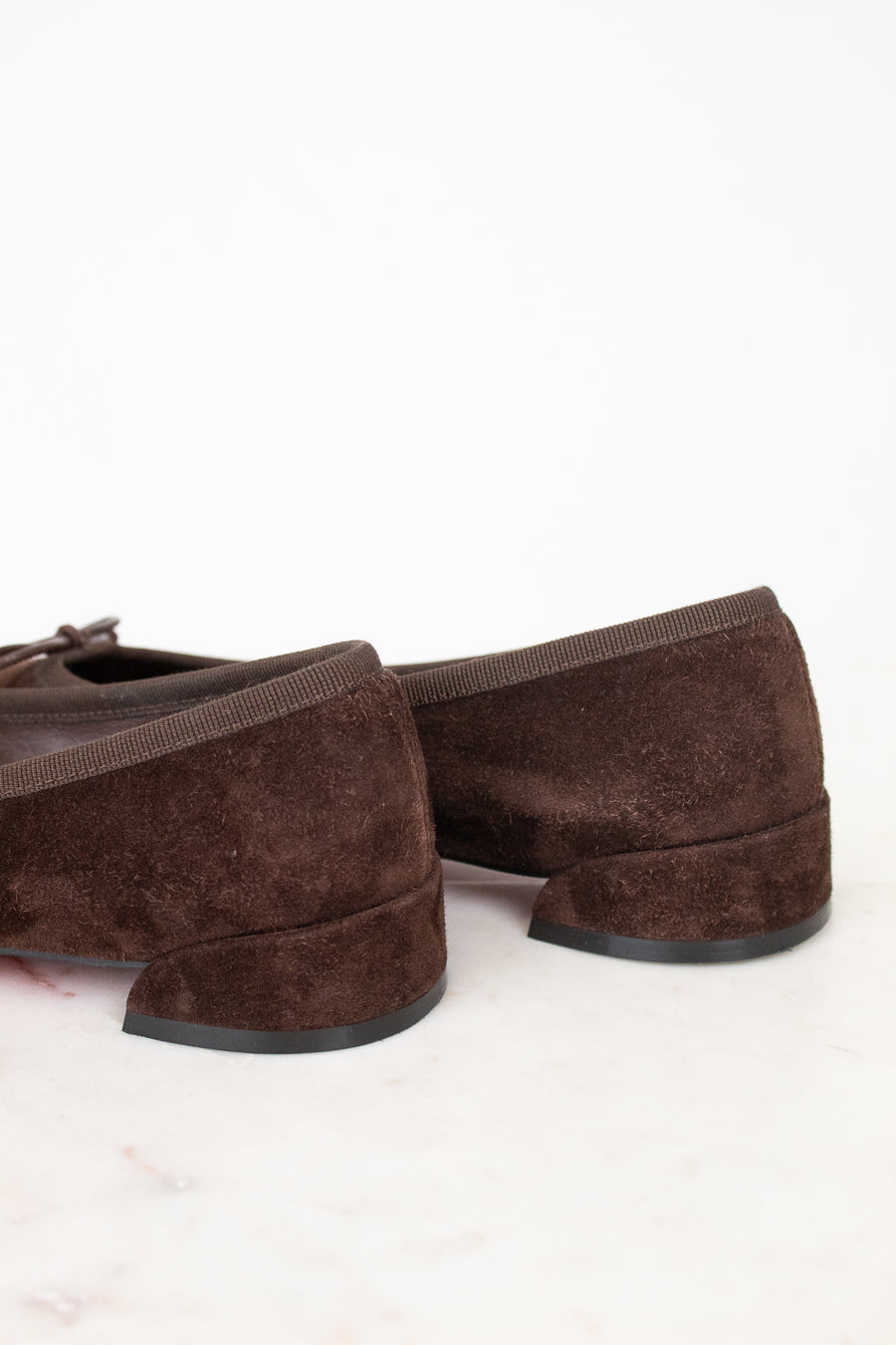 Heel view of brown suede ballet flats