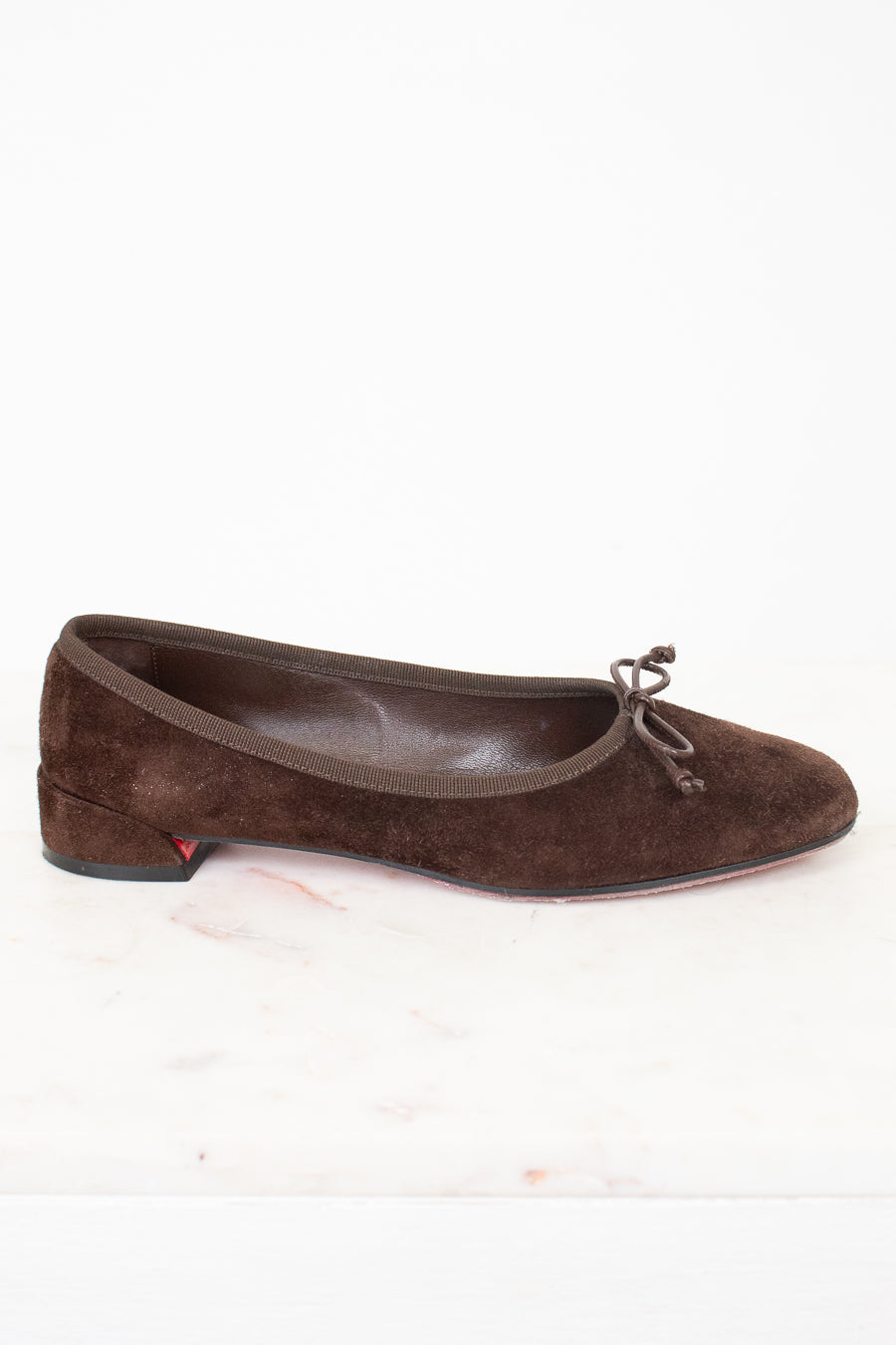 Side view of brown suede ballet flats