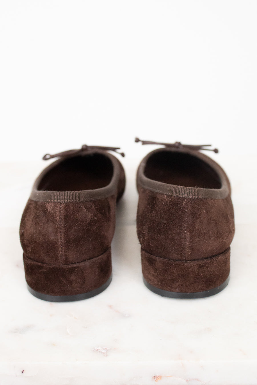 Heel view of brown suede flats