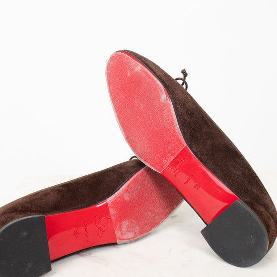 Red bottoms of brown suede flats