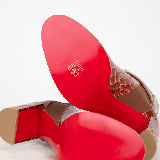 Red and brown shoe soles on a light background