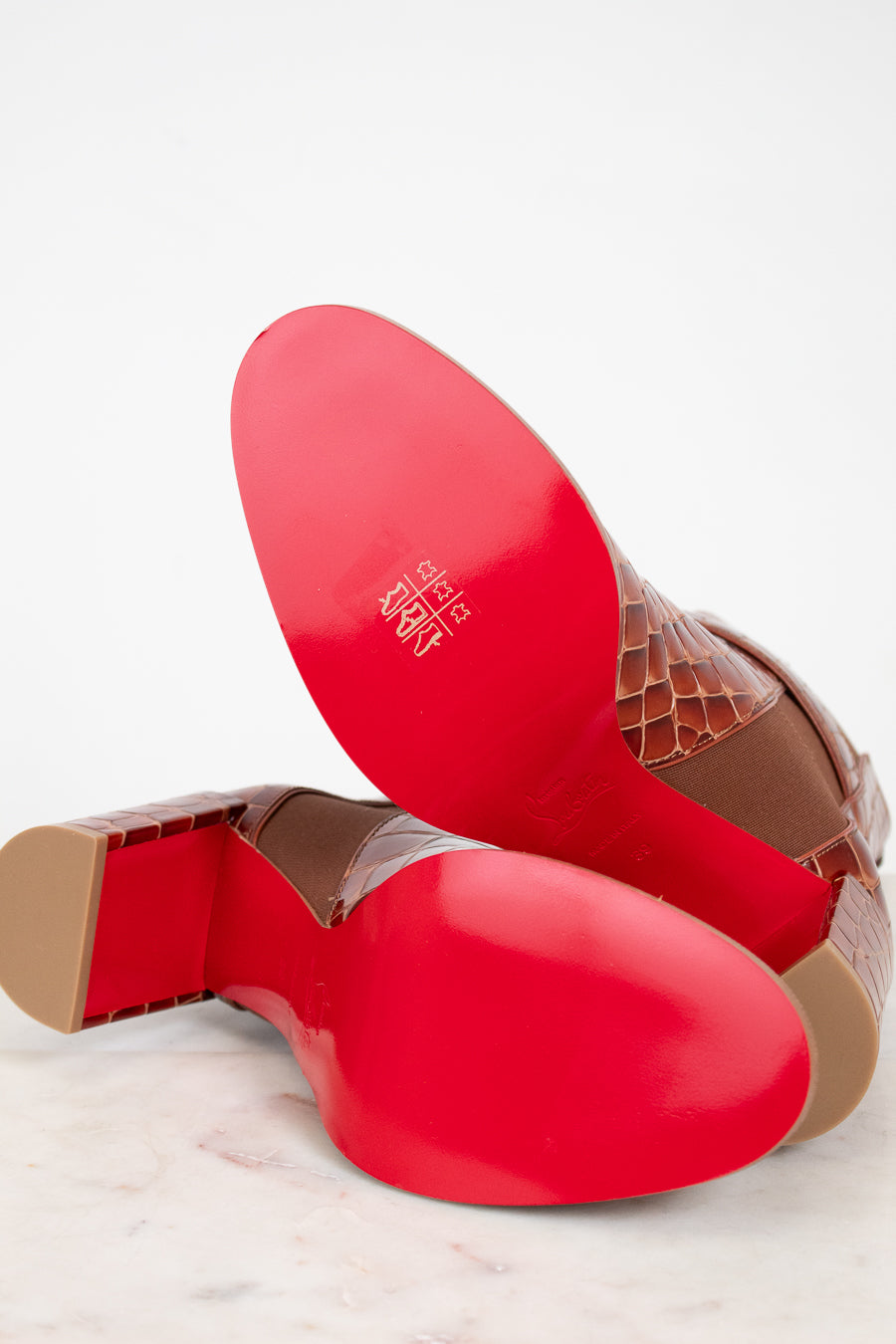 Red and brown shoe soles on a light background