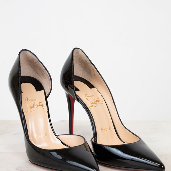 Pair of black high-heeled shoes on a white background