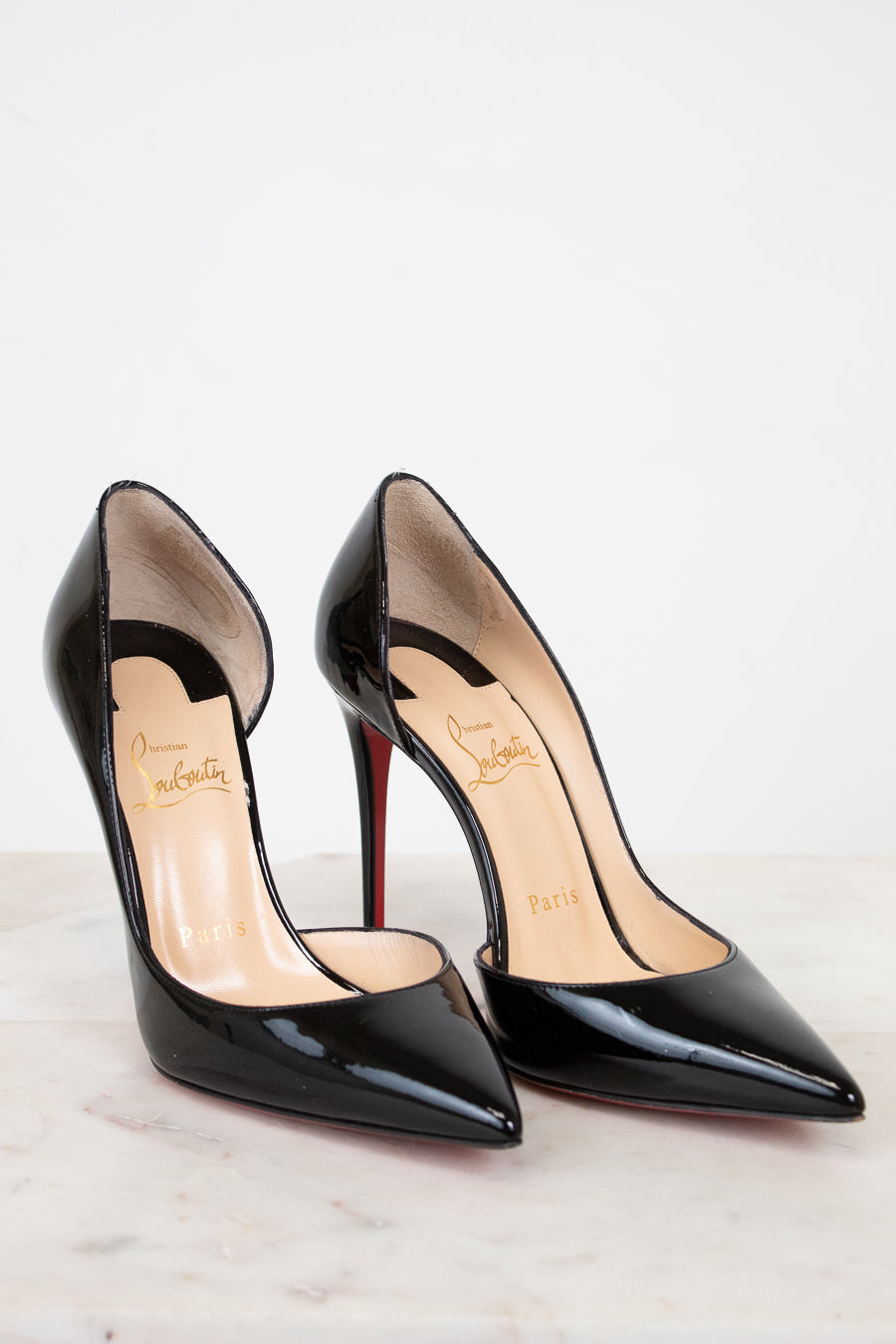 Pair of black high-heeled shoes on a white background