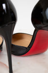 Close-up of a black and red high-heeled shoe on a light background