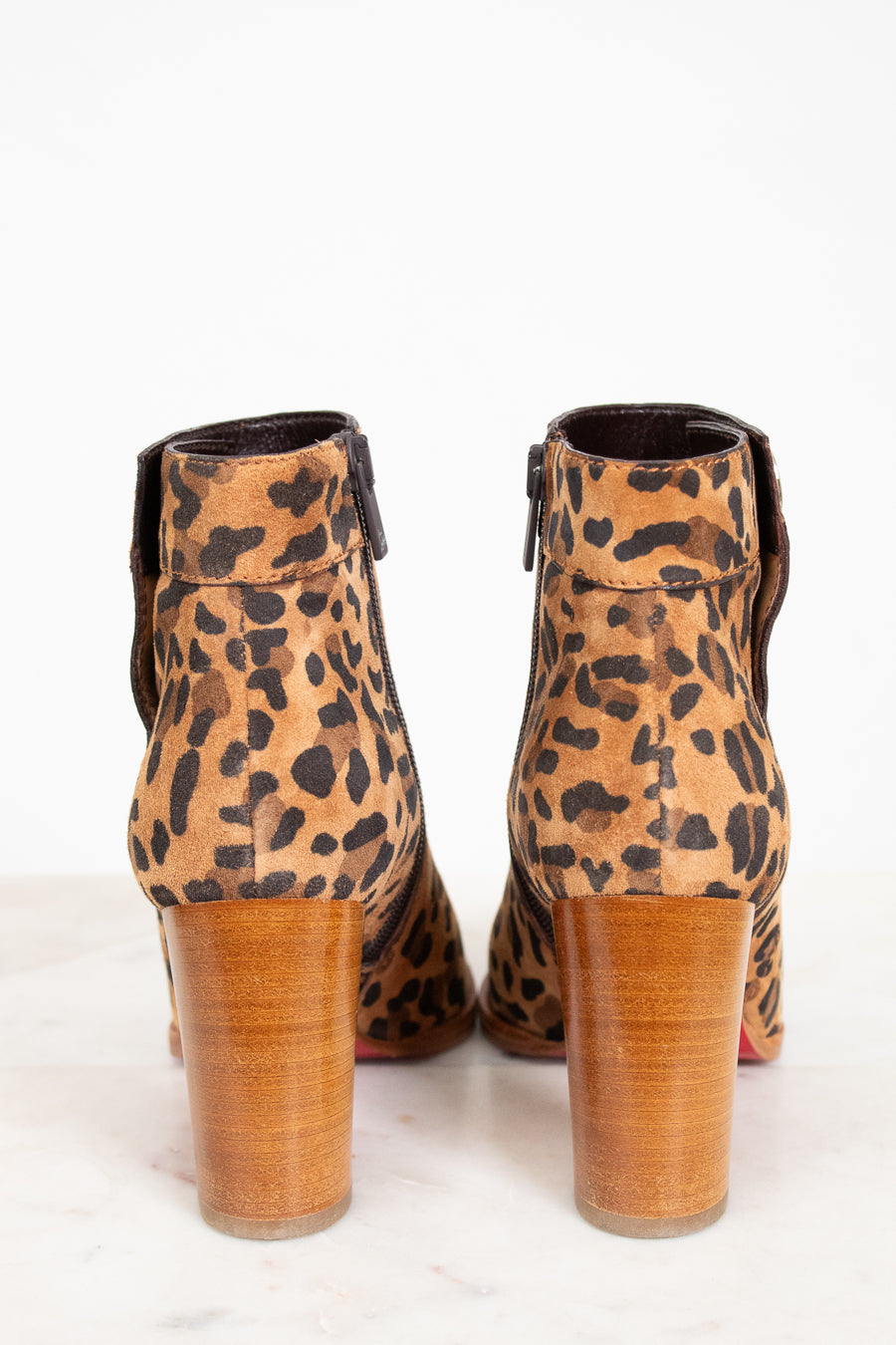 Leopard print ankle boots on a white background