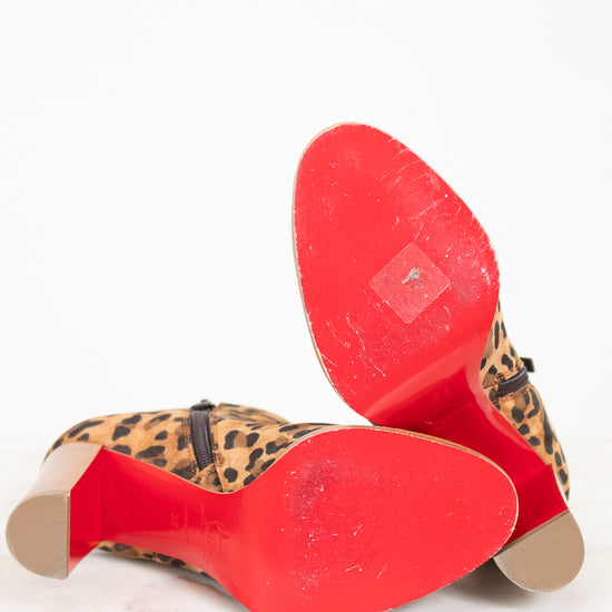Close-up of red soles with leopard print pattern on a white background