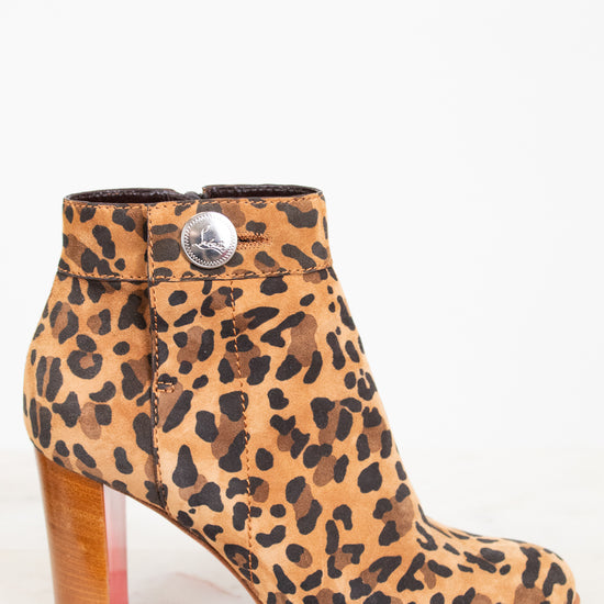 Leopard print boot with a wooden heel on a white background