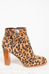 Leopard print boot with a wooden heel on a white background