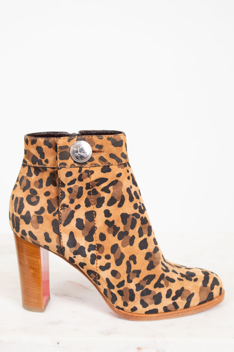 Leopard print boot with a wooden heel on a white background