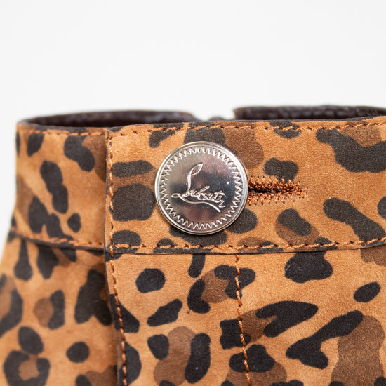 Leopard print boot close up with a button on a white background