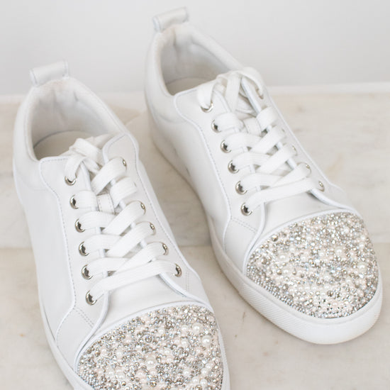 White sneakers with glittery accents on a light background