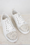 White sneakers with glittery accents on a light background