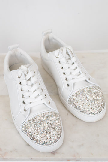 White sneakers with glittery accents on a light background