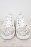 White sneakers with crystal and pearl accents on a light background
