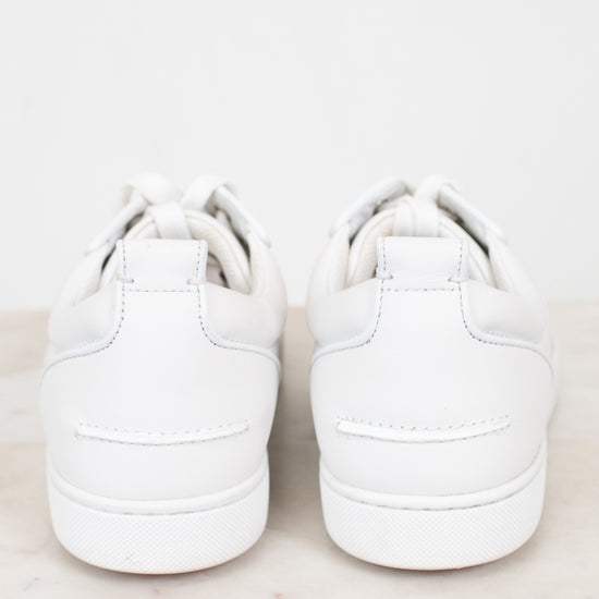 Pair of white sneakers on a light gray background