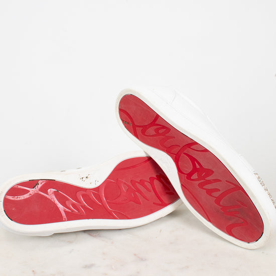 Red and white soles of sneakers on a marble surface