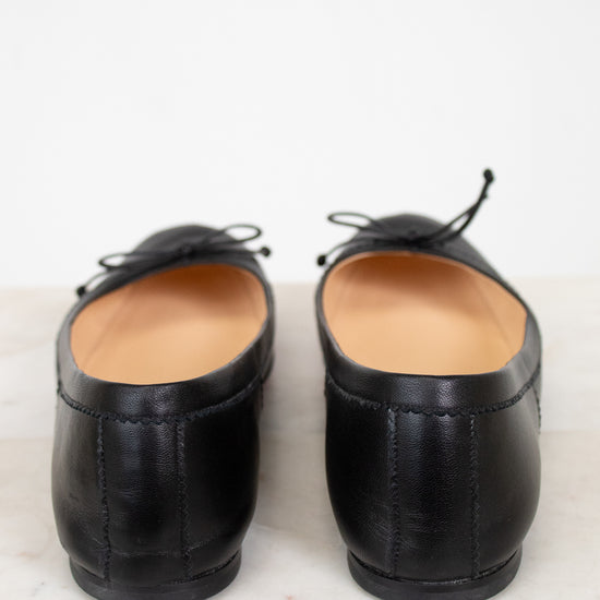 Pair of black leather shoes on a light marble surface