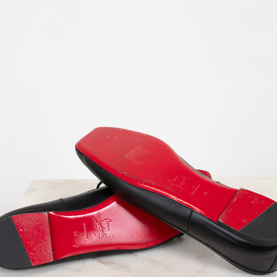Red and black shoes on a marble surface