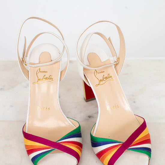White sandals with rainbow straps on a white background