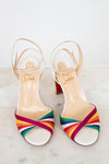 White sandals with rainbow straps on a white background