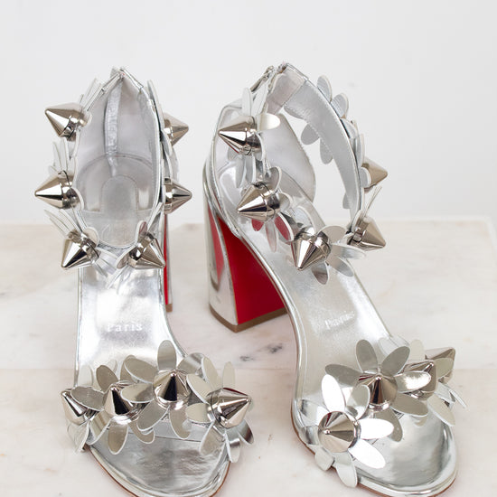 Silver studded high-heeled shoes on a white background