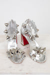 Silver studded high-heeled shoes on a white background