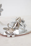 Close-up of silver studded floral shoe on a white background