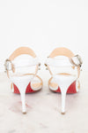 White high-heeled shoes with red bottom soles on a white background