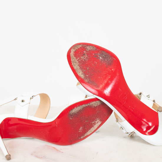 Worn red bottom of high-heeled shoes on a white background