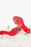 Worn red bottom of high-heeled shoes on a white background