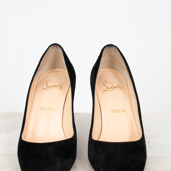 Pair of black high-heeled shoes with brand logo on a white background