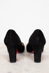 Black suede high-heeled shoes on a white background