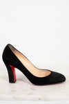 Black high-heeled shoe with a red sole on a white background