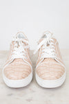Pair of crocodile print beige sneakers with white soles on a light background