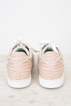 Pair of light pink crocodile-patterned sneakers on a white background