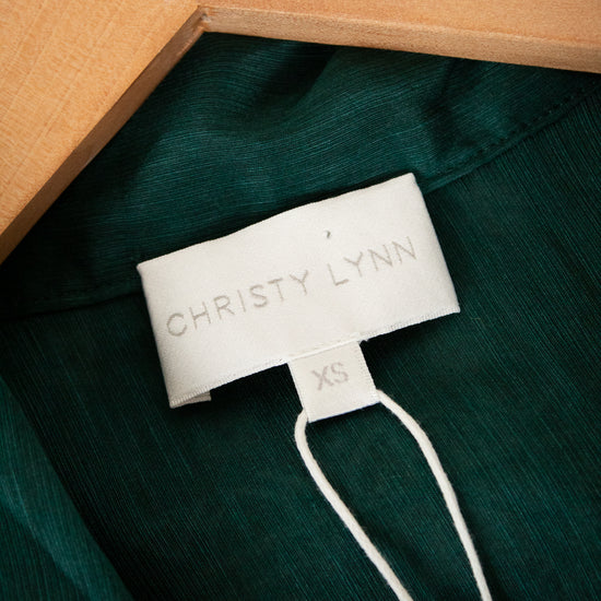 Green shirt with a Christy Lynn label on a green background