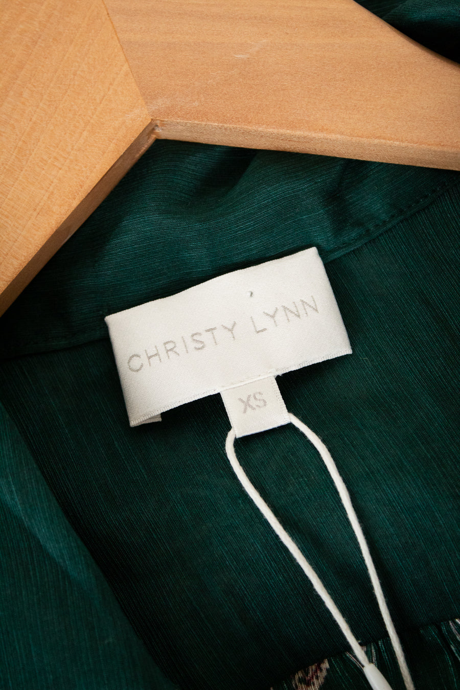Green shirt with a Christy Lynn label on a green background