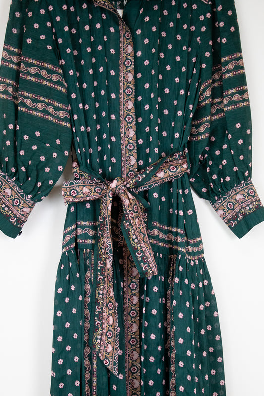 Green patterned dress with a belt on a white background