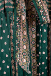 Close-up of green fabric with floral and paisley patterns
