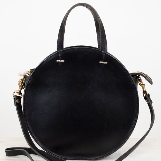 Black handbag with gold accents on a white background