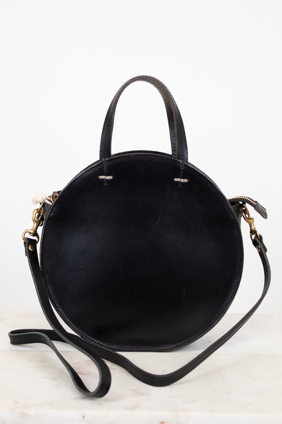Black handbag with gold accents on a white background