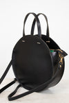 Black leather handbag with a strap on a white background
