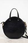 Black round handbag with gold accents on a white background