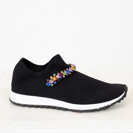 Black slip-on sneaker with colorful embellishments on a white background