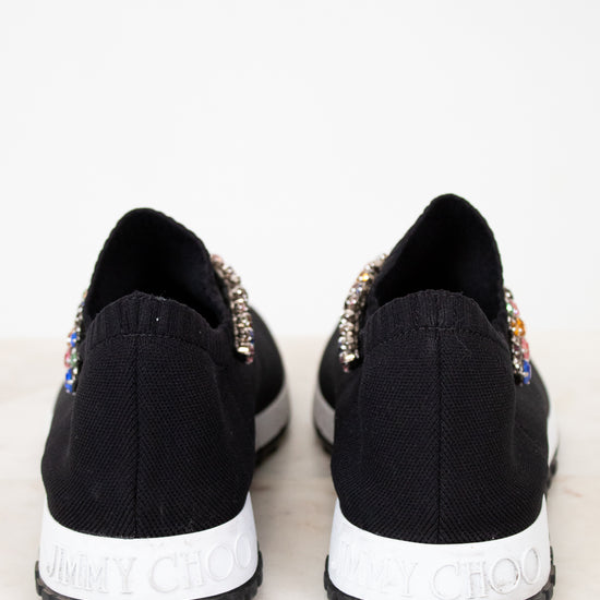 Black sneakers with embellishments on a white background