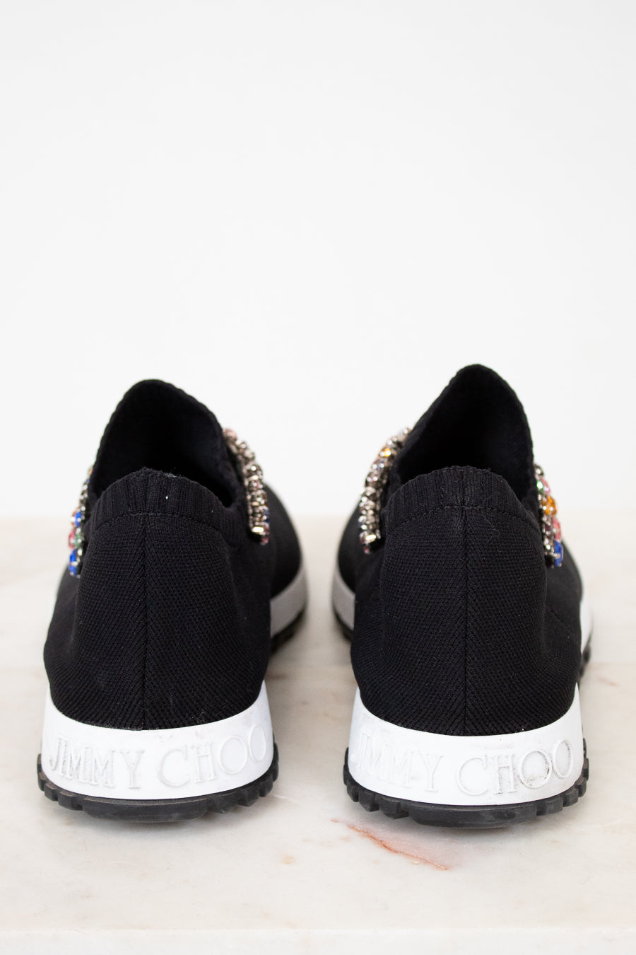Black sneakers with embellishments on a white background
