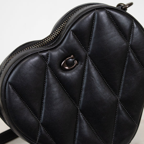 Black quilted handbag on a light background