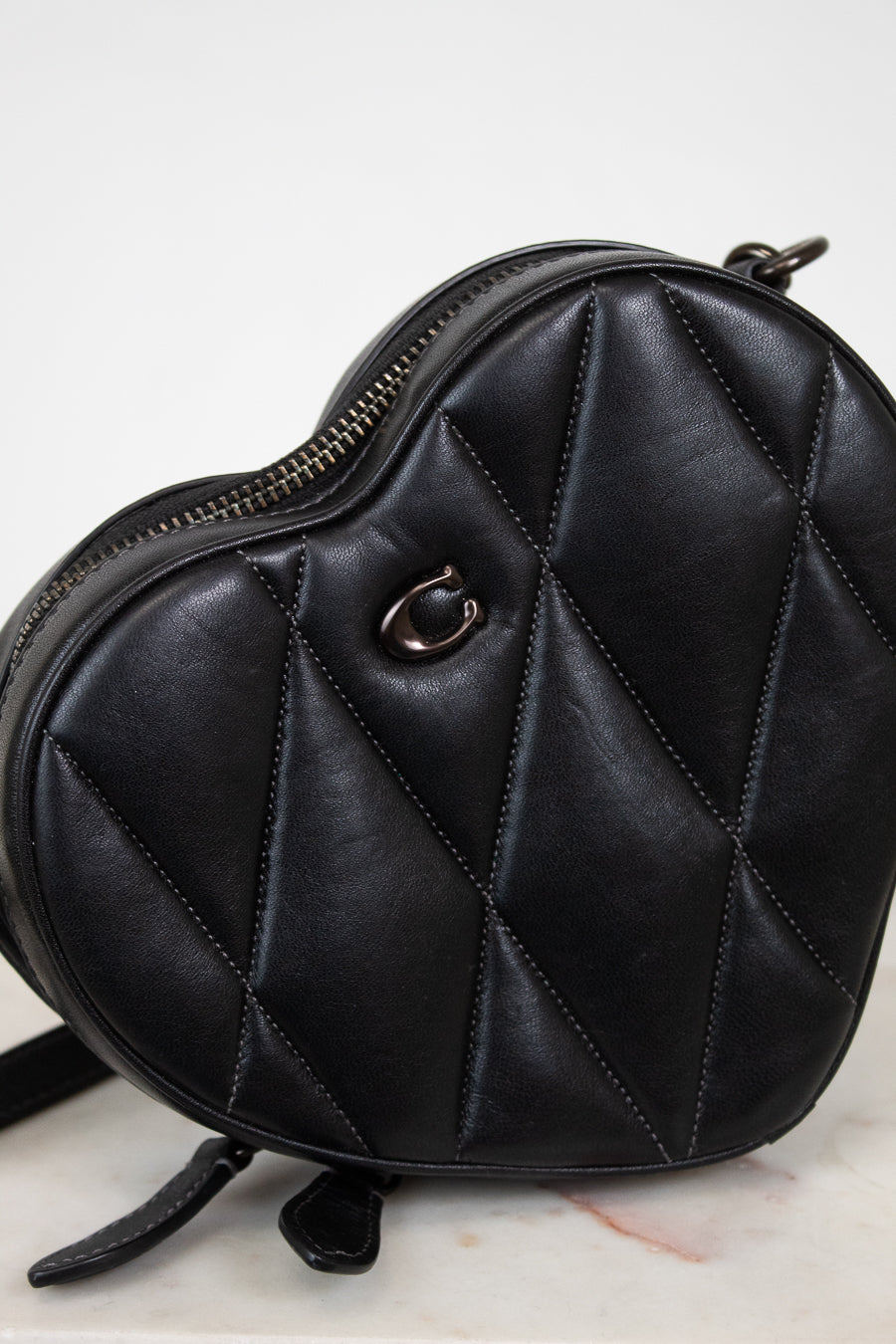 Black quilted handbag on a light background
